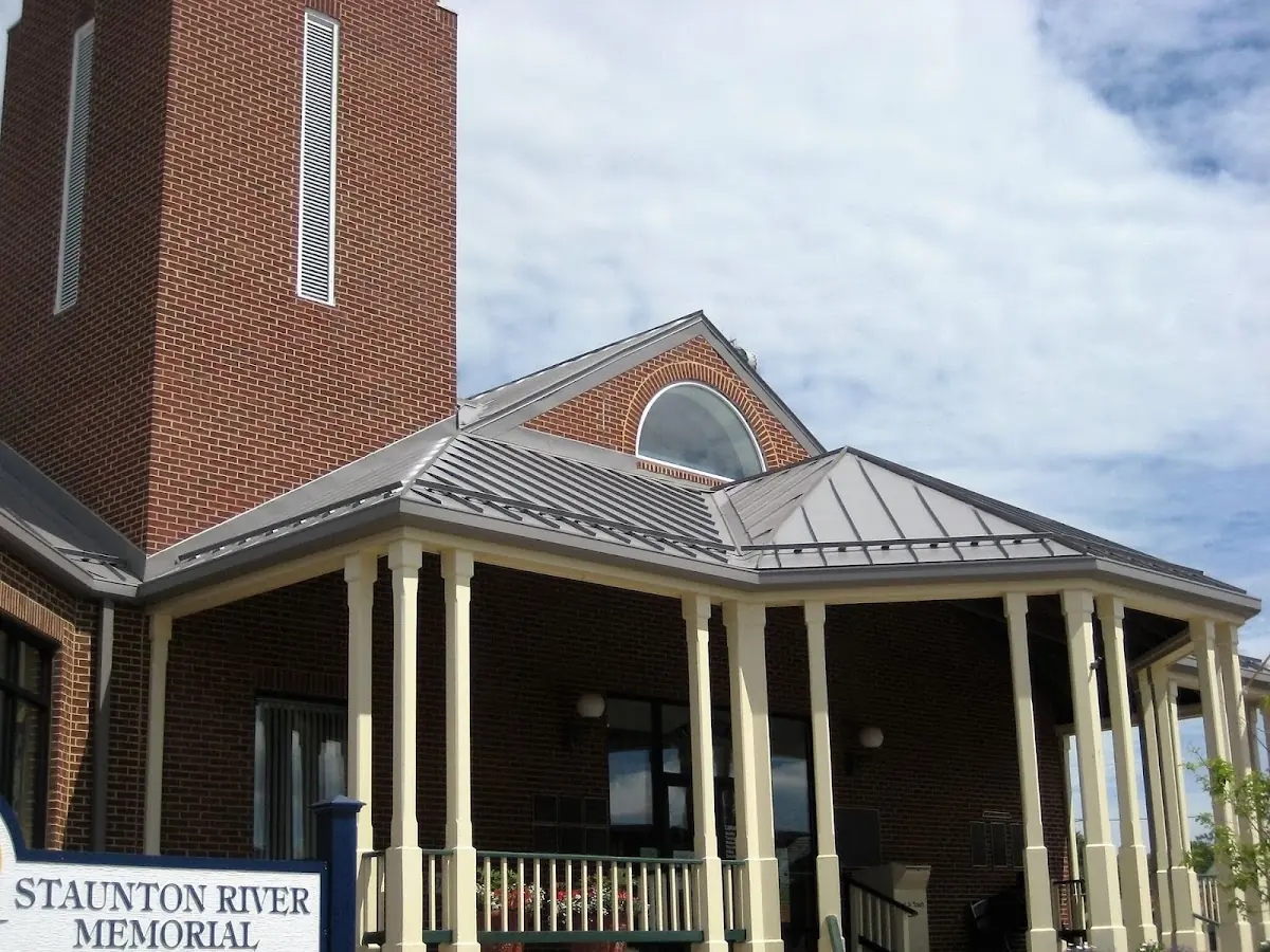 Skilled roofing craftsmen working on a residential roof in Huron